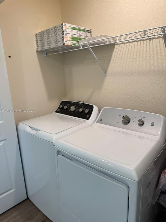 5029 N Dogwood Cir, La Belle, FL 33935 - laundry area featuring independent washer and dryer and dark wood finished floors