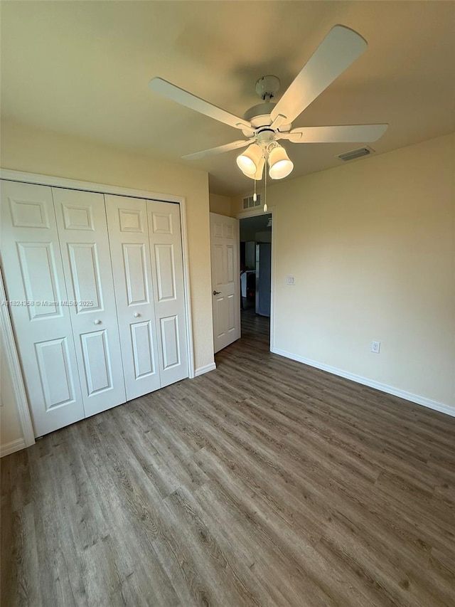 5029 N Dogwood Cir, La Belle, FL 33935 - unfurnished bedroom with wood finished floors, a closet, and a ceiling fan