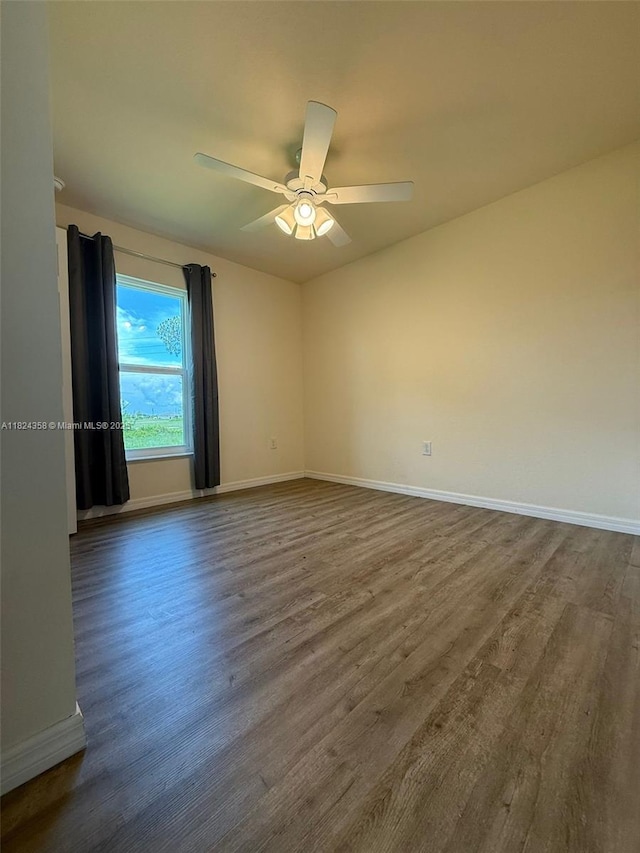 5029 N Dogwood Cir, La Belle, FL 33935 - empty room featuring dark wood-style floors and ceiling fan