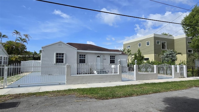 3640 SW 13th St, Miami, FL 33145 - view of front of house featuring stucco siding, a gate, and a fenced front yard