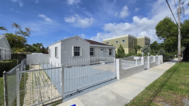 3640 SW 13th St, Miami, FL 33145 - view of front of home featuring a gate, stucco siding, and a fenced front yard