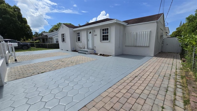 3640 SW 13th St, Miami, FL 33145 - view of front facade with stucco siding and a gate
