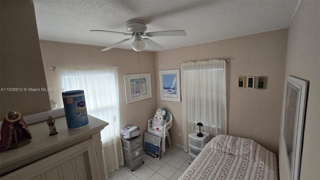 3640 SW 13th St, Miami, FL 33145 - bedroom with light tile patterned floors, a textured ceiling, and ceiling fan