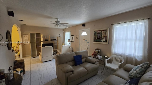 3640 SW 13th St, Miami, FL 33145 - living area featuring ceiling fan, a textured ceiling, light tile patterned floors, and arched walkways