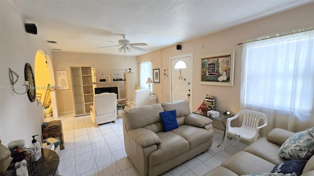3640 SW 13th St, Miami, FL 33145 - living room with ceiling fan, tile patterned floors, arched walkways, and a textured ceiling
