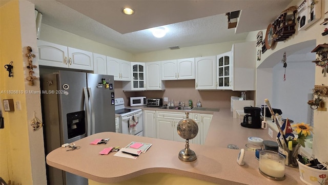 3640 SW 13th St, Miami, FL 33145 - kitchen featuring white appliances, glass insert cabinets, white cabinets, a peninsula, and recessed lighting