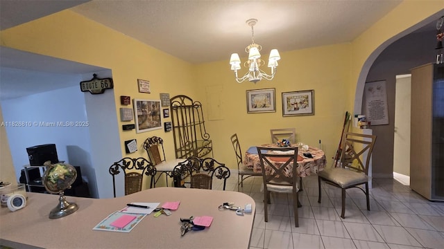 3640 SW 13th St, Miami, FL 33145 - tiled dining room featuring arched walkways and a chandelier