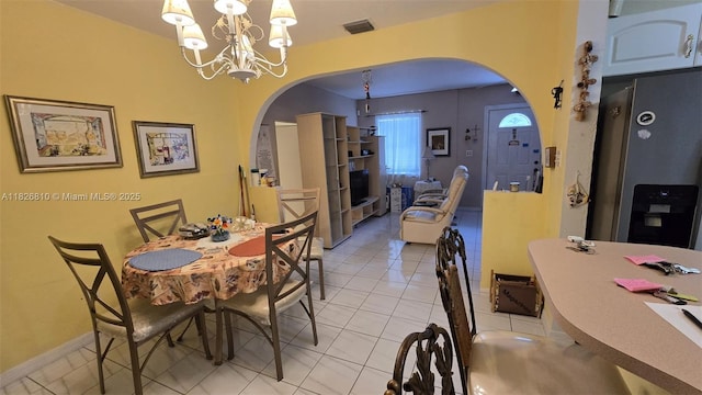 3640 SW 13th St, Miami, FL 33145 - dining area featuring arched walkways, a chandelier, and light tile patterned floors