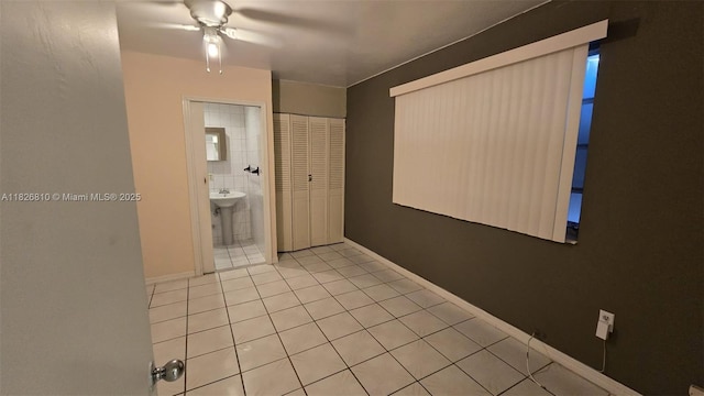 3640 SW 13th St, Miami, FL 33145 - unfurnished bedroom featuring tile patterned floors, a closet, ensuite bathroom, and ceiling fan