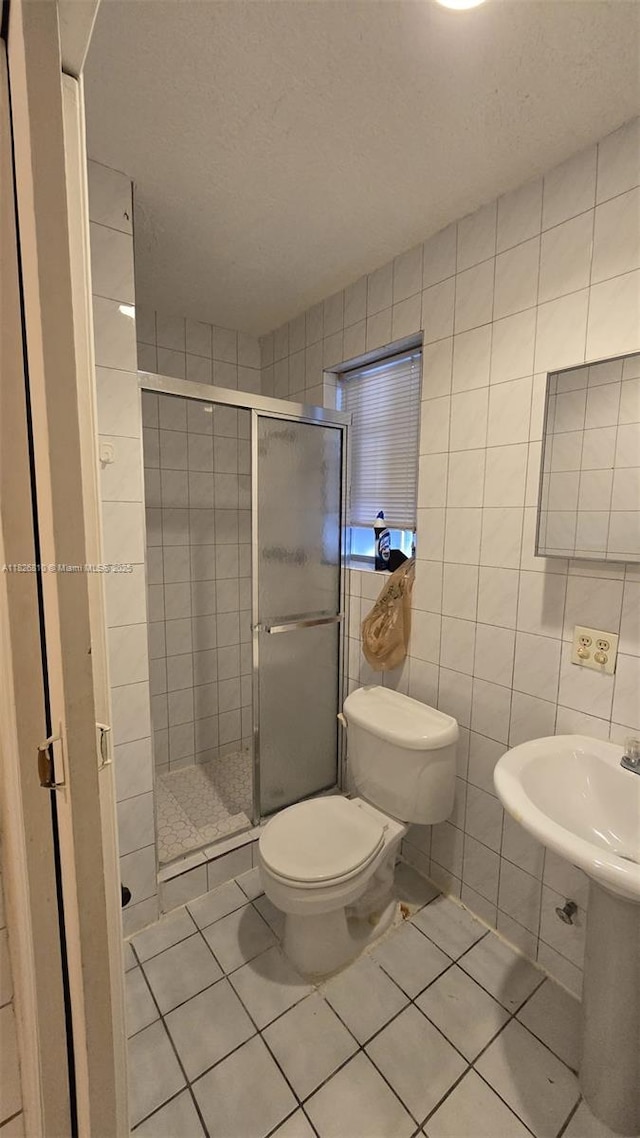 3640 SW 13th St, Miami, FL 33145 - full bathroom featuring tile patterned floors, a shower stall, tile walls, and a textured ceiling