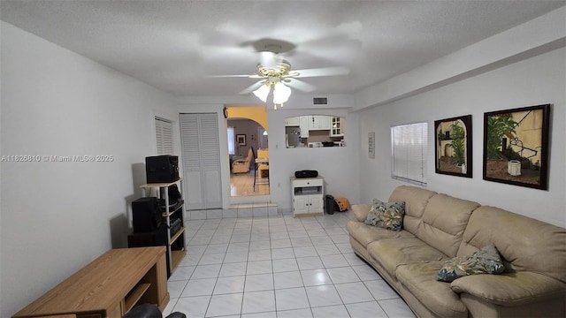3640 SW 13th St, Miami, FL 33145 - living room featuring arched walkways, a ceiling fan, and light tile patterned floors
