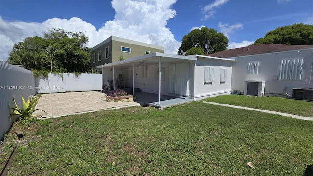 3640 SW 13th St, Miami, FL 33145 - back of property featuring a fenced backyard, a patio area, and stucco siding