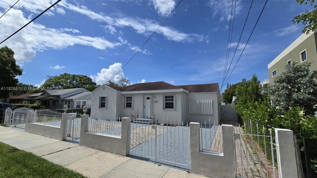3640 SW 13th St, Miami, FL 33145 - bungalow-style home featuring stucco siding, a gate, and a fenced front yard