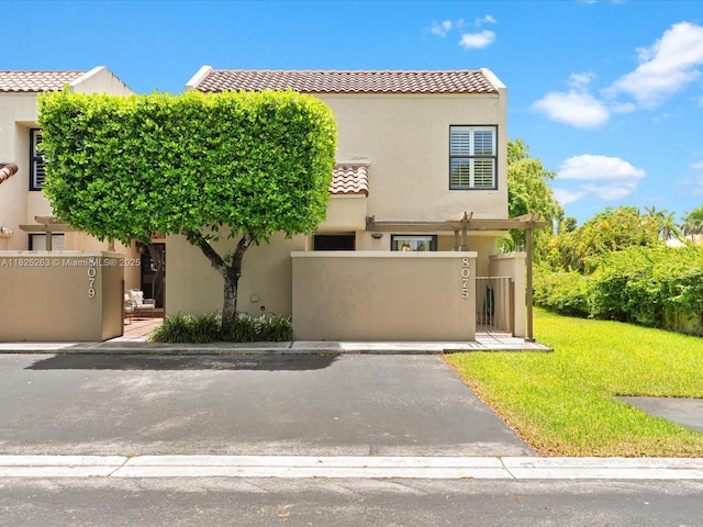 8075 SW 86th Ter, Miami, FL 33143 - view of front of house with a tile roof, stucco siding, and a gate