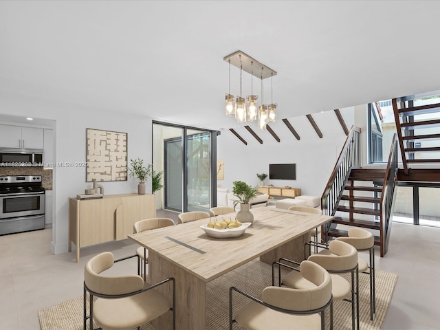 8075 SW 86th Ter, Miami, FL 33143 - dining room featuring stairs and a chandelier
