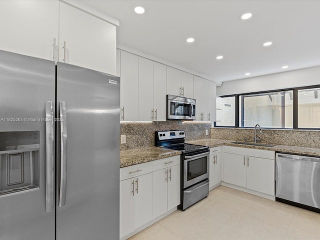 8075 SW 86th Ter, Miami, FL 33143 - kitchen with stainless steel appliances, white cabinetry, stone counters, and recessed lighting