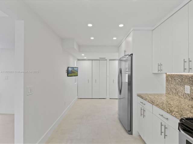 8075 SW 86th Ter, Miami, FL 33143 - kitchen featuring freestanding refrigerator, recessed lighting, white cabinetry, light stone counters, and range