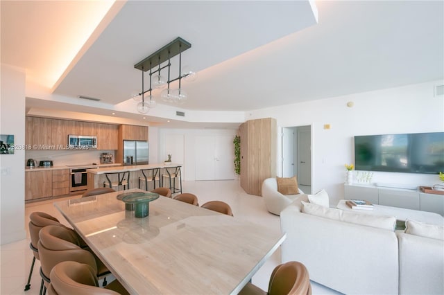 3131 NE 188th St Unit 2-605, Aventura, FL 33180 - dining space with a tray ceiling and light tile patterned floors
