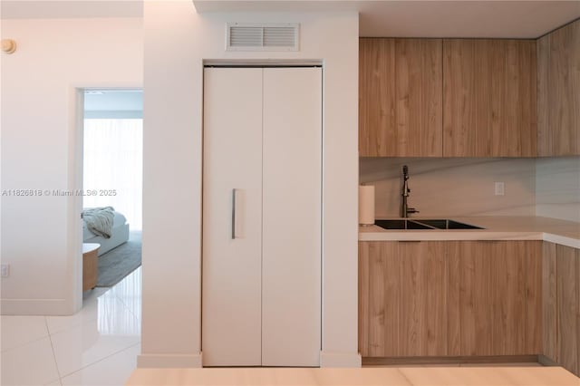 3131 NE 188th St Unit 2-605, Aventura, FL 33180 - kitchen featuring modern cabinets, light countertops, fridge, and light tile patterned floors
