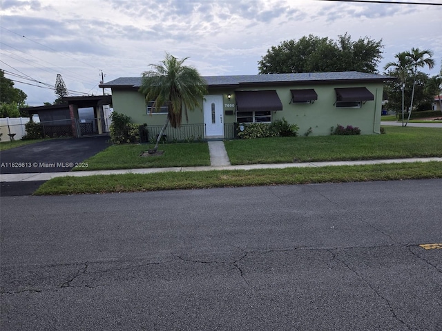 7600 Simms St, Hollywood, FL 33024 - view of front of house featuring asphalt driveway and stucco siding