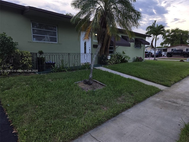 7600 Simms St, Hollywood, FL 33024 - view of side of property featuring a yard and stucco siding