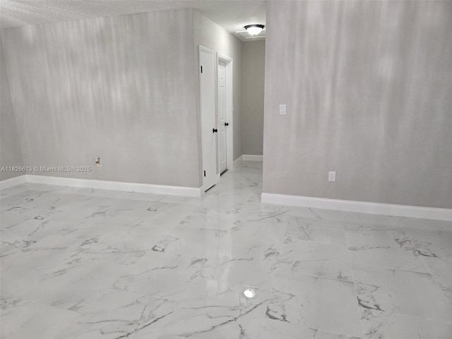 7600 Simms St, Hollywood, FL 33024 - empty room featuring light marble finish floors and a textured ceiling