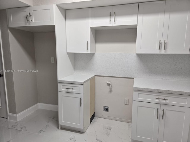 7600 Simms St, Hollywood, FL 33024 - kitchen featuring light marble finish floors, light countertops, and white cabinets