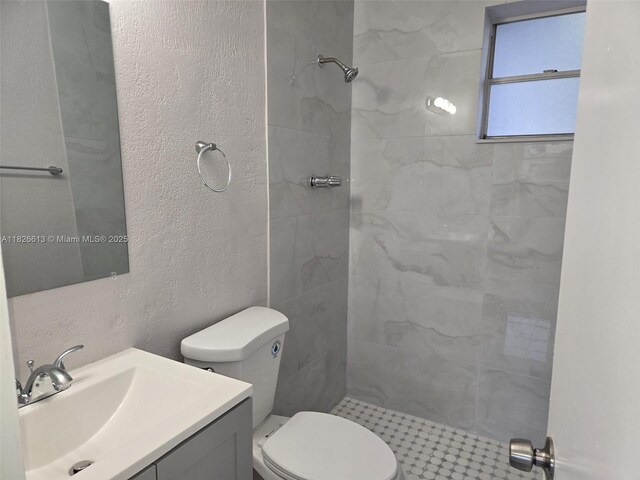 7600 Simms St, Hollywood, FL 33024 - bathroom featuring tiled shower, vanity, and a textured wall