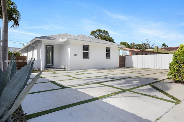525 El Prado, West Palm Beach, FL 33405 - back of property with stucco siding, a patio, and a shingled roof