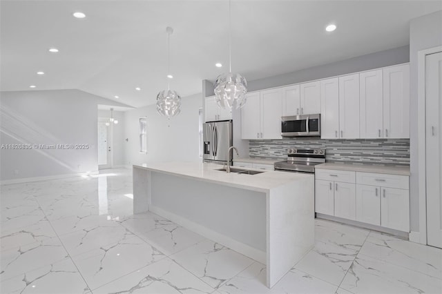 525 El Prado, West Palm Beach, FL 33405 - kitchen with appliances with stainless steel finishes, light marble finish floors, recessed lighting, white cabinets, and vaulted ceiling
