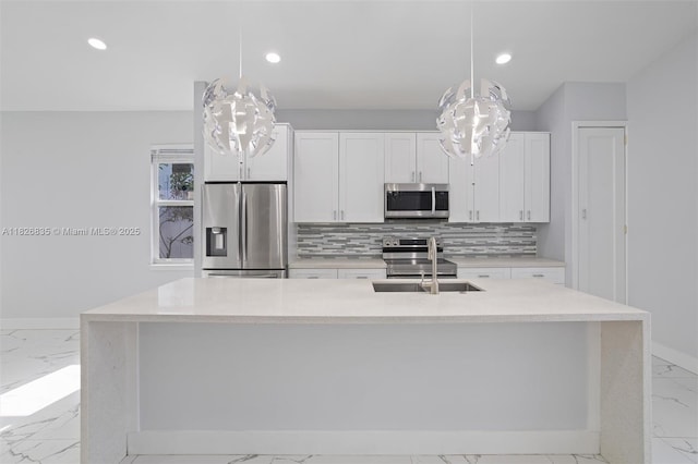525 El Prado, West Palm Beach, FL 33405 - kitchen with stainless steel appliances, light marble finish floors, decorative backsplash, recessed lighting, and white cabinetry