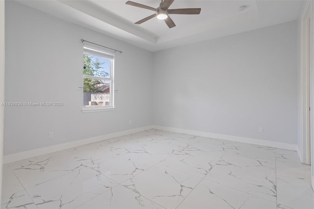 525 El Prado, West Palm Beach, FL 33405 - unfurnished room featuring a tray ceiling, ceiling fan, and marble finish floors