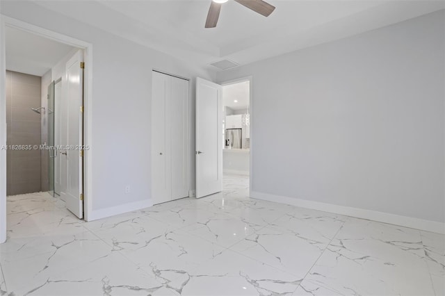 525 El Prado, West Palm Beach, FL 33405 - unfurnished bedroom featuring marble finish flooring, ensuite bathroom, a closet, and ceiling fan
