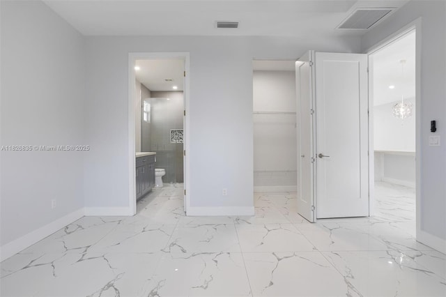 525 El Prado, West Palm Beach, FL 33405 - unfurnished bedroom with a spacious closet, light marble finish floors, ensuite bath, recessed lighting, and a closet