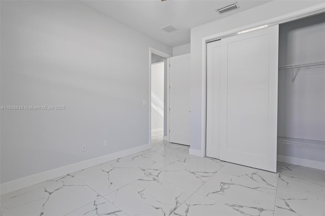 525 El Prado, West Palm Beach, FL 33405 - unfurnished bedroom with light marble finish floors and a closet