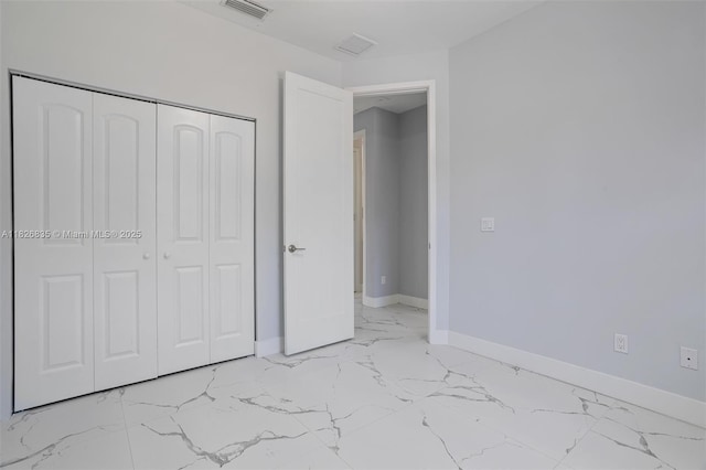 525 El Prado, West Palm Beach, FL 33405 - unfurnished bedroom with light marble finish floors and a closet