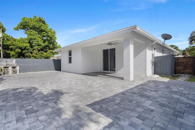 525 El Prado, West Palm Beach, FL 33405 - rear view of property with a gate, ceiling fan, stucco siding, and a patio area