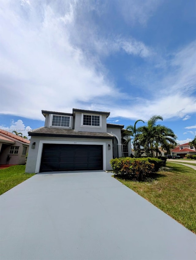 335 SW 183rd Way, Pembroke Pines, FL 33029 - view of front of property featuring concrete driveway, stucco siding, a garage, and a front lawn