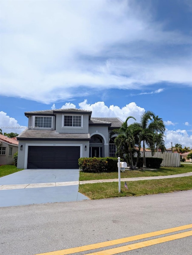 335 SW 183rd Way, Pembroke Pines, FL 33029 - view of front of house with a garage, concrete driveway, stucco siding, and a tile roof