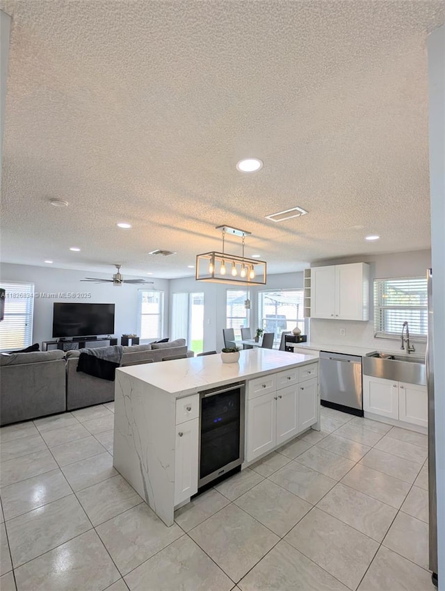 335 SW 183rd Way, Pembroke Pines, FL 33029 - kitchen featuring stainless steel dishwasher, wine cooler, a textured ceiling, recessed lighting, and a kitchen island