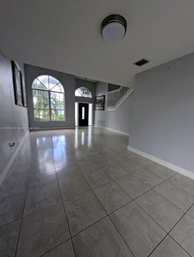 335 SW 183rd Way, Pembroke Pines, FL 33029 - foyer featuring a textured ceiling and baseboards