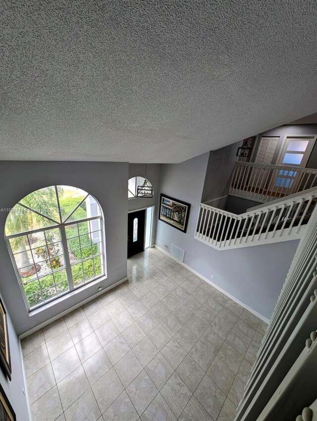 335 SW 183rd Way, Pembroke Pines, FL 33029 - unfurnished living room featuring tile patterned flooring and a textured ceiling