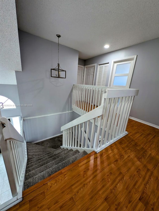 335 SW 183rd Way, Pembroke Pines, FL 33029 - stairway featuring a textured ceiling, wood finished floors, and recessed lighting