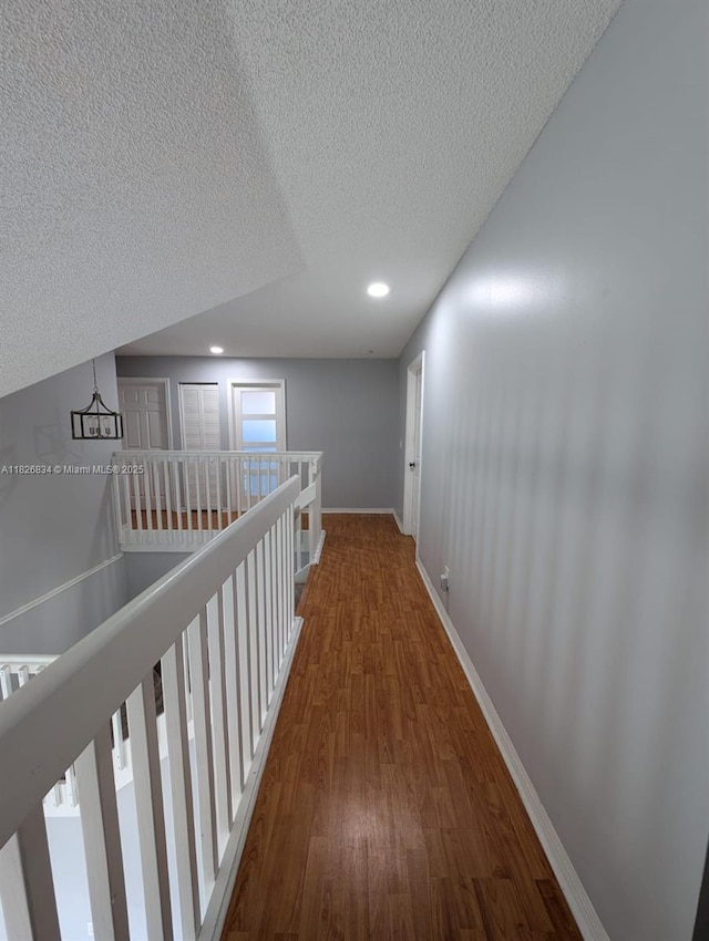 335 SW 183rd Way, Pembroke Pines, FL 33029 - corridor with wood finished floors, a textured ceiling, recessed lighting, and an upstairs landing