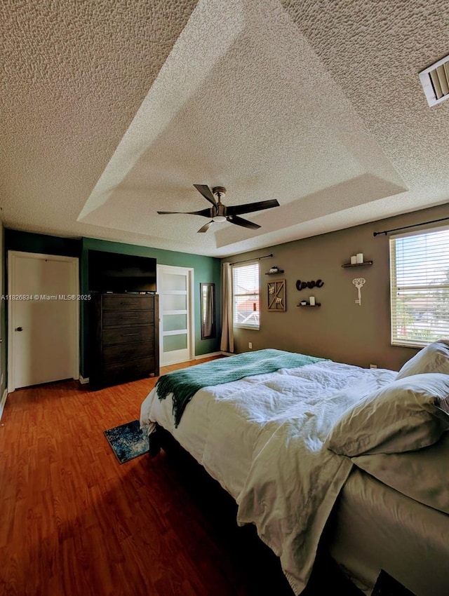 335 SW 183rd Way, Pembroke Pines, FL 33029 - bedroom with a textured ceiling, multiple windows, light wood-style flooring, and a ceiling fan