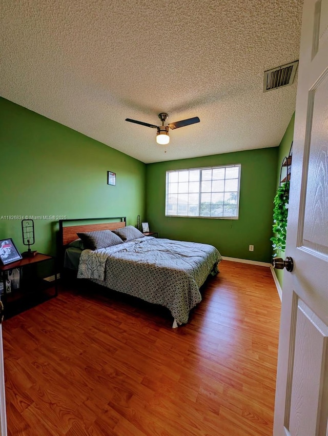 335 SW 183rd Way, Pembroke Pines, FL 33029 - bedroom with wood finished floors, a ceiling fan, and a textured ceiling