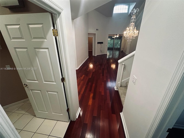 3125 Stonewater Dr Lakeland Fl, Lakeland Fl, FL 33803 - corridor with light wood finished floors, stairway, a chandelier, and a towering ceiling