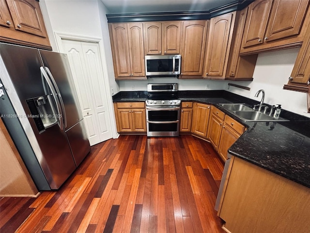 3125 Stonewater Dr Lakeland Fl, Lakeland Fl, FL 33803 - kitchen featuring appliances with stainless steel finishes, dark wood-style flooring, brown cabinetry, and dark stone countertops
