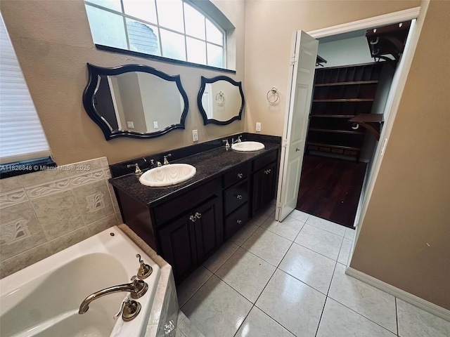 3125 Stonewater Dr Lakeland Fl, Lakeland Fl, FL 33803 - full bathroom with a spacious closet, a bath, tile patterned flooring, and double vanity