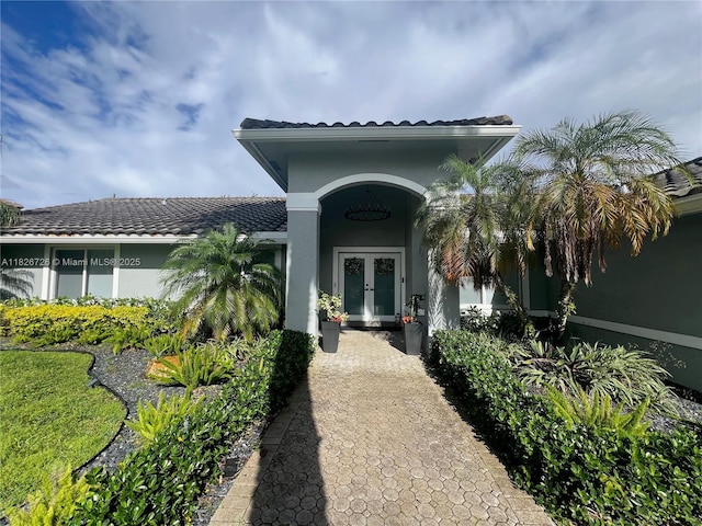 1732 SW 103rd Ln, Davie, FL 33324 - property entrance featuring french doors, stucco siding, and a tile roof